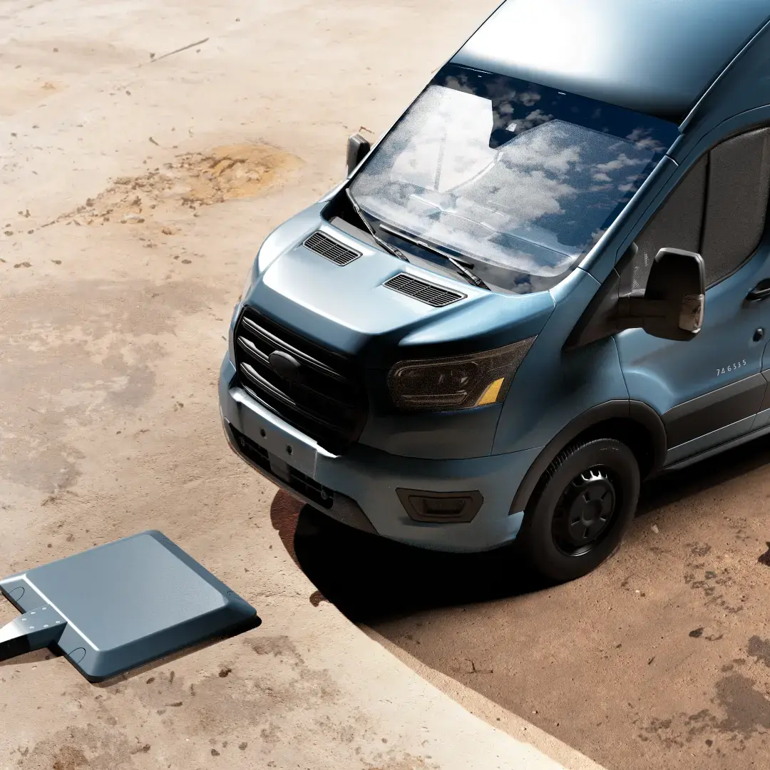 bluish van approaching charging pad