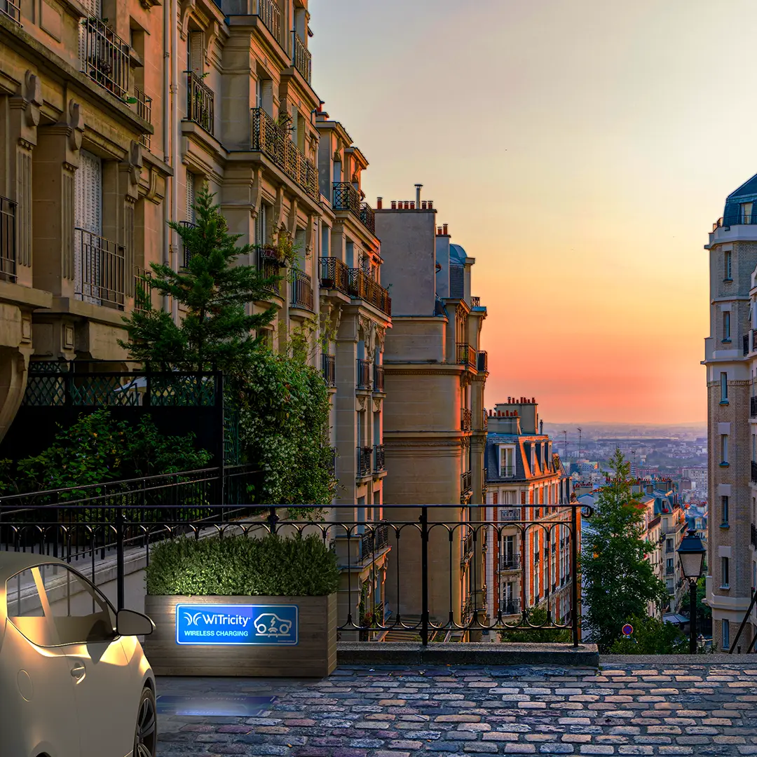Car charging wirelessly at dusk